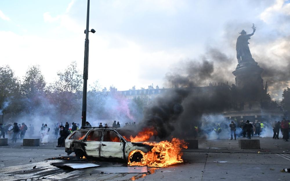 Scuffles and fires break out as protesters rally across France, joining students